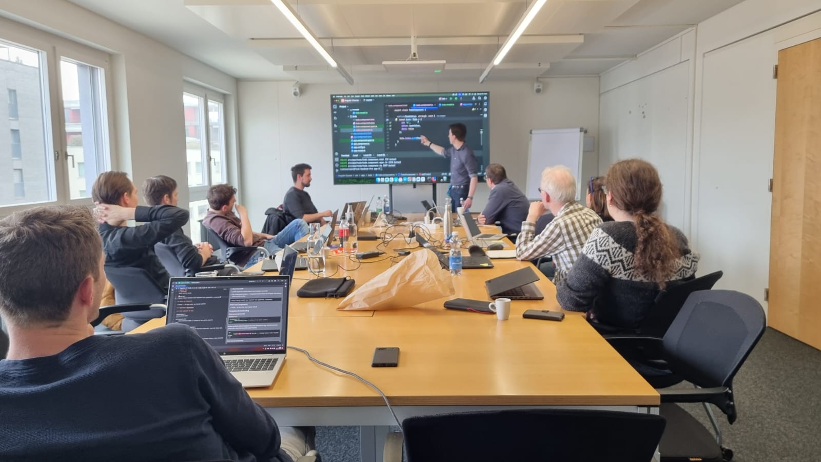 Fabian leading a training session in a conference room with developers.
